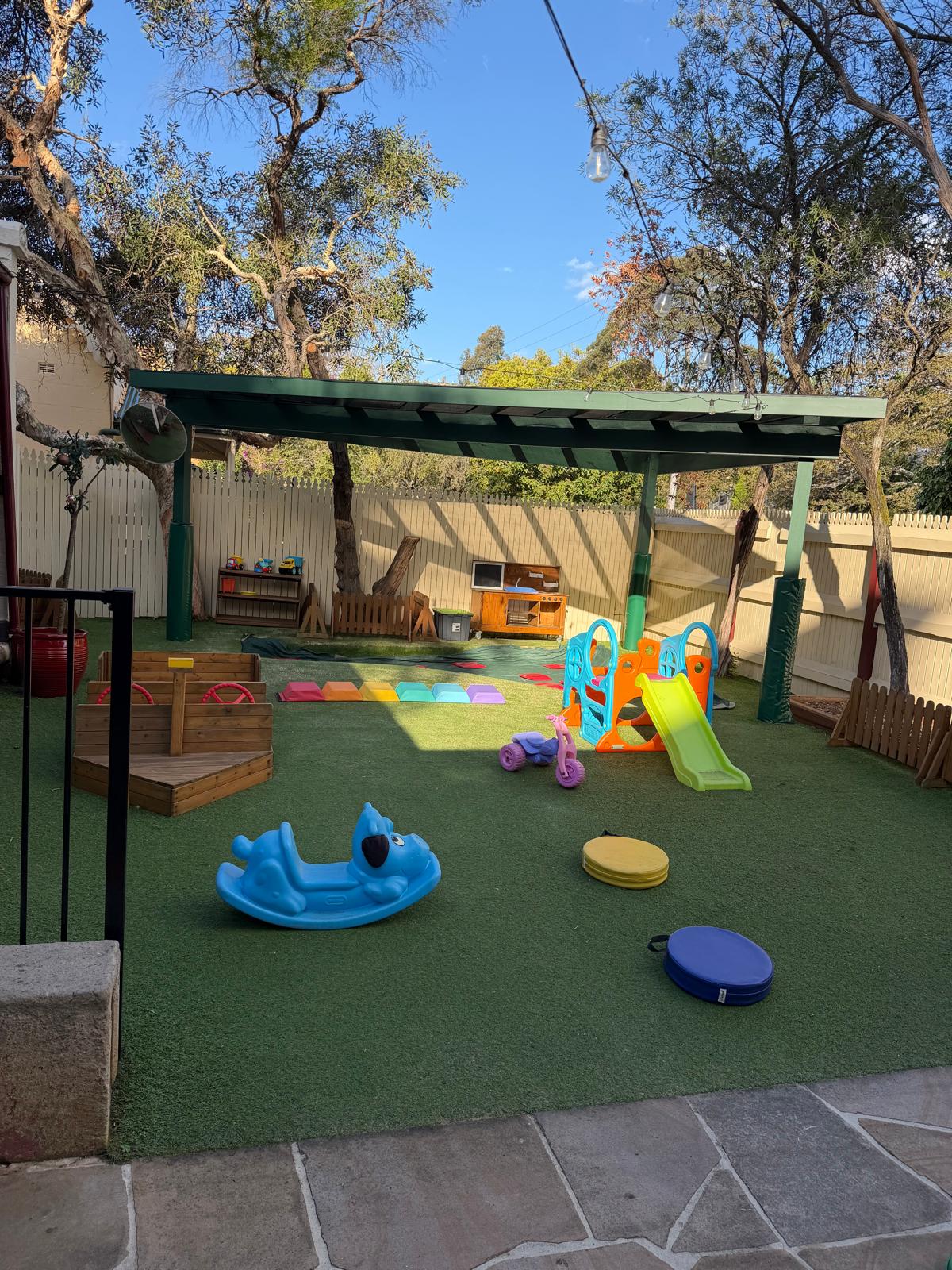 Children’s garden play area with plants and natural materials for outdoor discovery